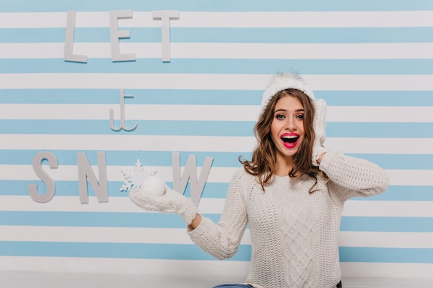 Free Photo surprised, funny model with funny face posing in over lettering "let it snow"