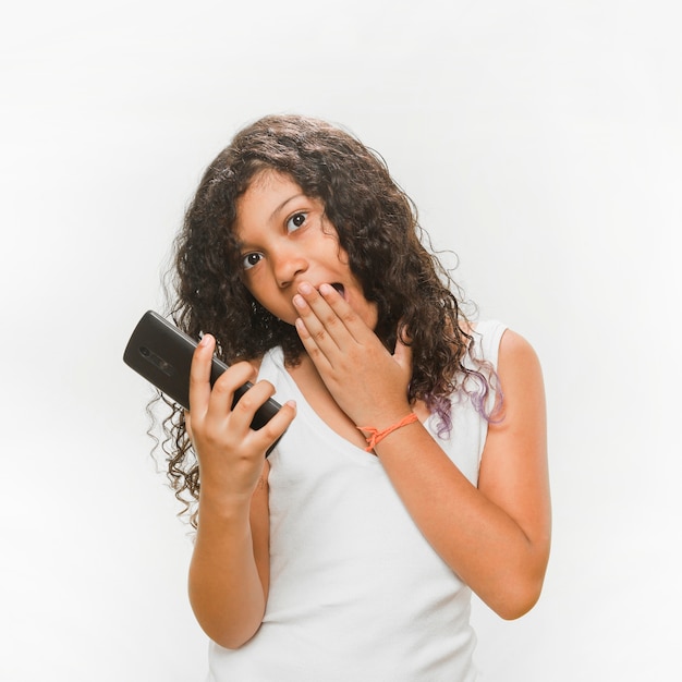 Surprised girl holding mobile phone