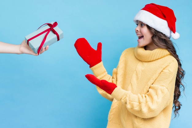 Free Photo surprised girl receiving gift on winter