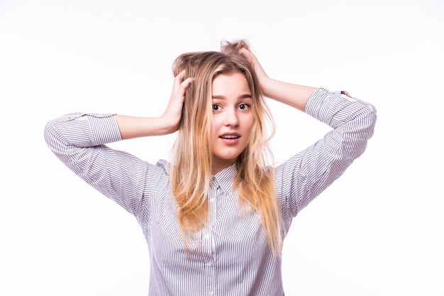 Surprised happy young woman looking sideways in excitement. Isolated over white wall