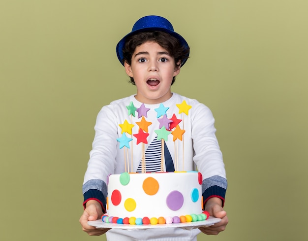 Free Photo surprised little boy wearing blue party hat holding out cake at camera 