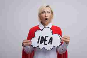 Free photo surprised middle-aged blonde superhero woman in red cape holding idea bubble looking at front isolated on white wall