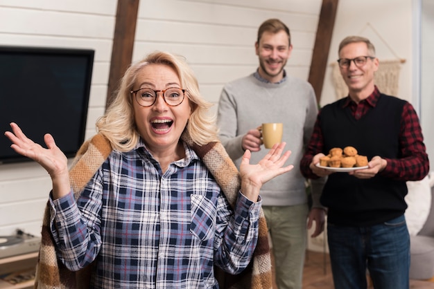 Free Photo surprised mother with son and father holding muffins