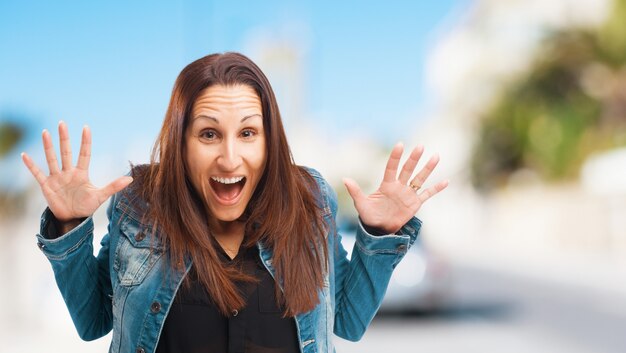 Surprised screaming woman with hands up