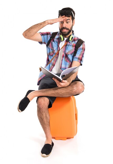 Surprised tourist reading book