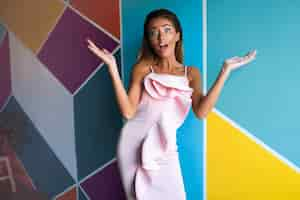 Free photo surprised woman in the pink dress, fashion model