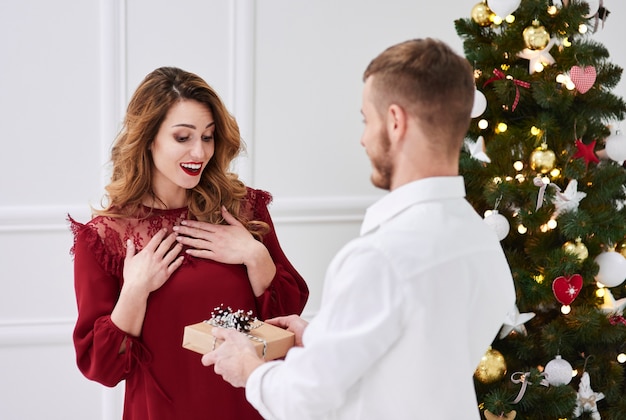 Surprised woman receiving a gift