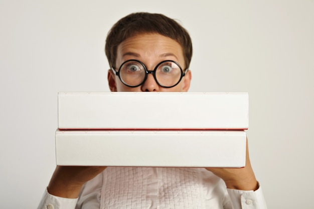 Surprised woman student holds two big folders with educational plan for new year in university Focus on folders