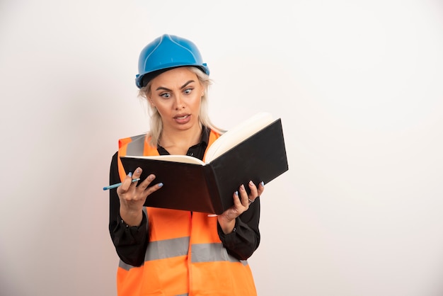 Surprised worker reading notes on white background. High quality photo