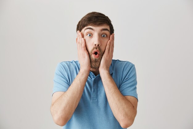 Surprised young bearded man posing