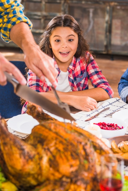 Free photo surprising girl at table near baked chicken