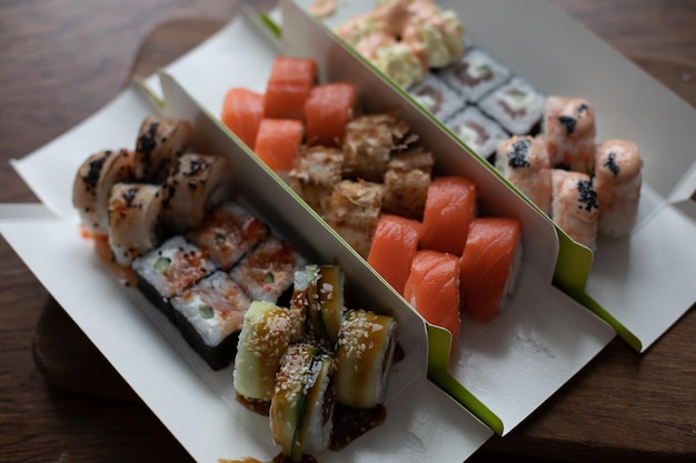 Free photo sushi of different types on a wooden stand delivery lunch dinner