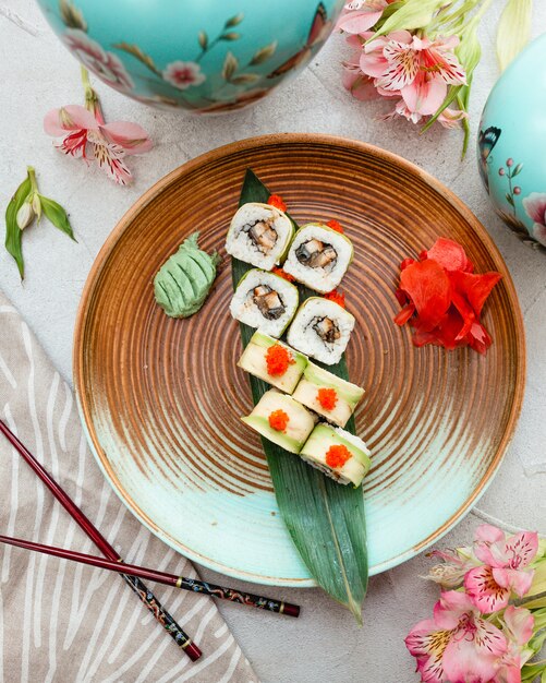 Sushi rolls inside blue brown design plate.