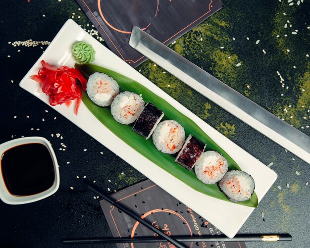 Sushi rolls on plate with sesame