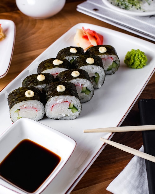 Sushi rolls served with soy sauce, ginger and wasabi