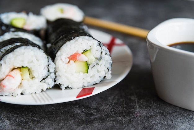 Sushi rolls, soy sauce and chopsticks