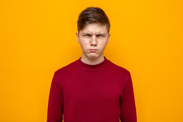 Suspicious young handsome guy wearing red sweater