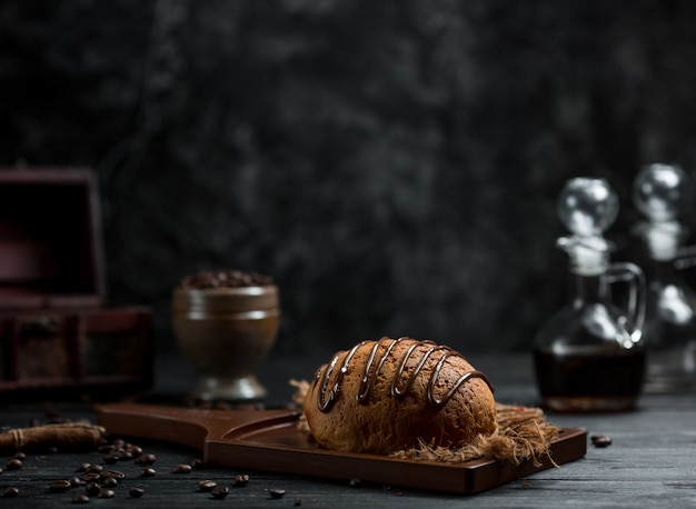 Sweet bun with chocolate syrup on it