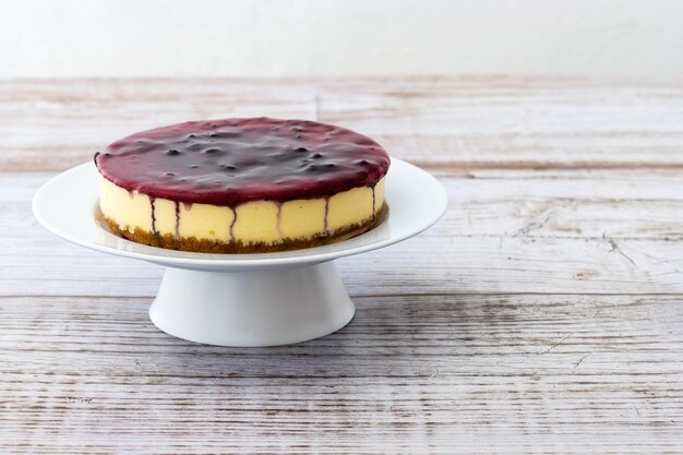 Sweet cheesecake with blue berry on wooden table