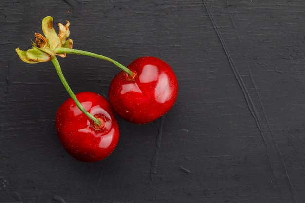 Free photo sweet cherries on dark grey table, flat lay.