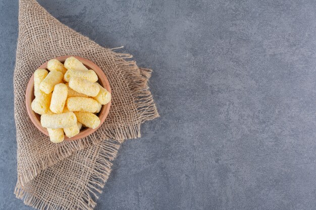 Sweet corn sticks in a bowl, on texture , on the marble surface