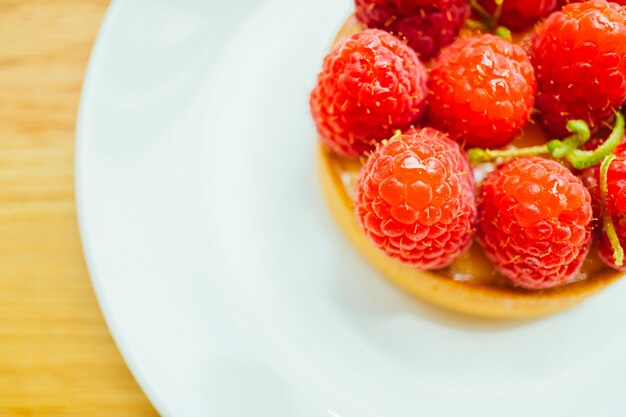 Sweet dessert custard tart with raspberry on top