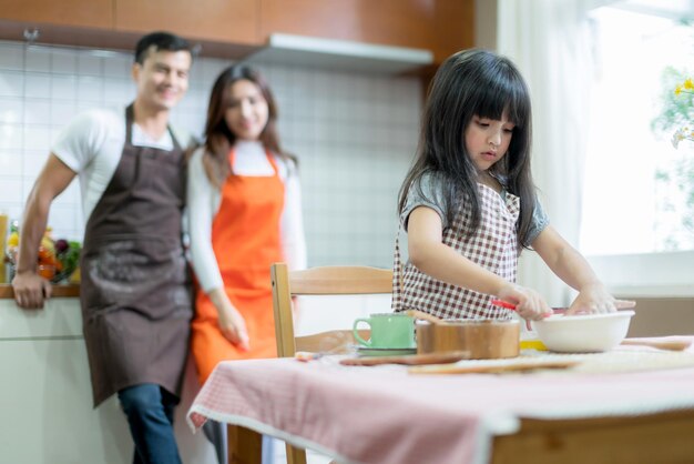 Sweet family weekend activities cooking together with dad mom and daughter happiness moment and joyful hobby home kitchen background