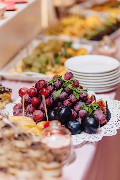 Sweet festive buffet, fruit, caps, macaroni and lots of sweets