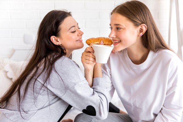 Sweet lesbian couple eating breakfast