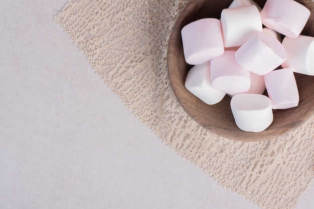 Free Photo sweet marshmallows on wooden board on burlap