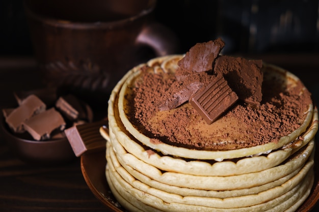 Sweet pancakes chocolate topping. Homemade pancakes with chocolate breakfast. Morning dessert cocoa pancakes on a plate