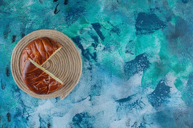 Sweet pastries on a trivet , on the marble table. 