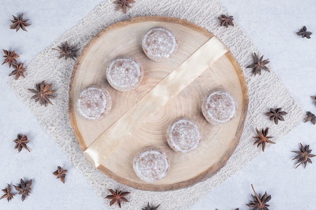 Sweet pastries with dried star anise on wooden plate