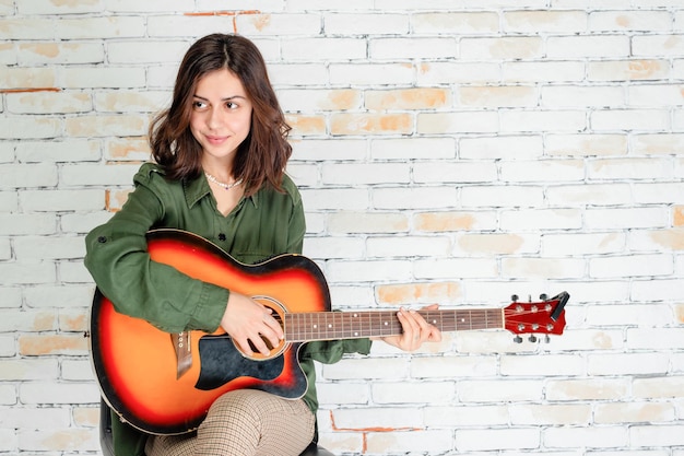 Sweet performer playing her guitar