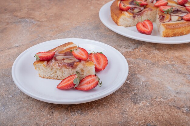 Sweet pie with strawberry in a white plate