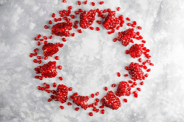 Sweet pomegranate seeds on concrete ,selective focus