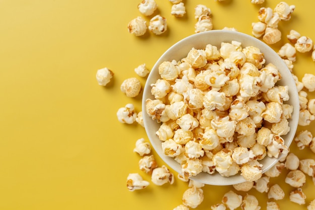 Sweet popcorn on yellow background