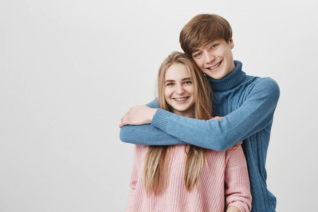 Free Photo sweet tender indoor shot of happy student couple hugging and cuddling