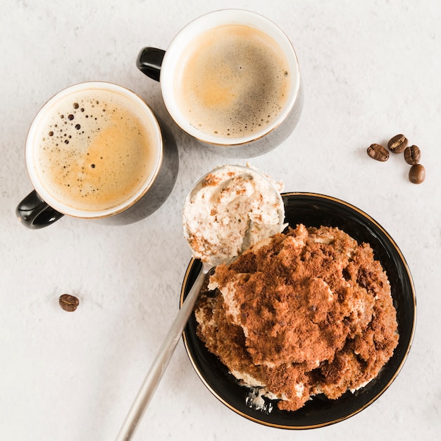 Free photo sweet tiramisu on white table with coffee