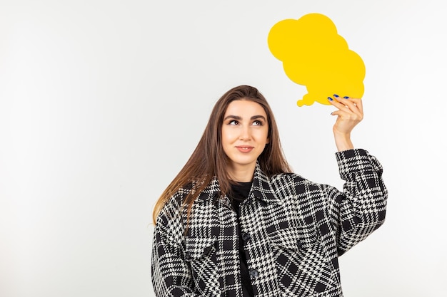 Sweet young lady holding talking box and standing white background