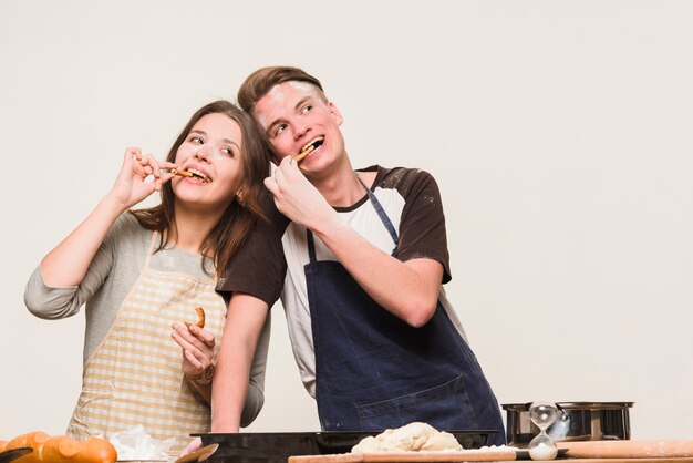 Sweethearts having fun with flour in kitchen