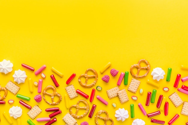 Sweets flat lay on yellow background