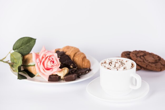 Sweets with rose flower on plate 