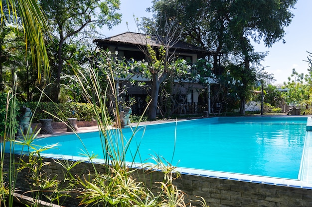 Free photo swimming pool  blue water and tropical garden with sea view background