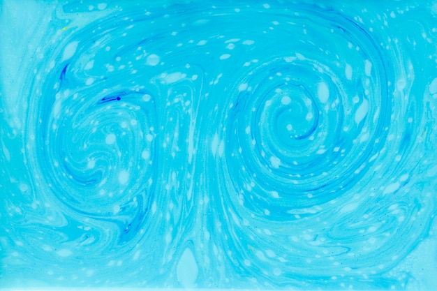 Free photo swirl of blue paint in liquid