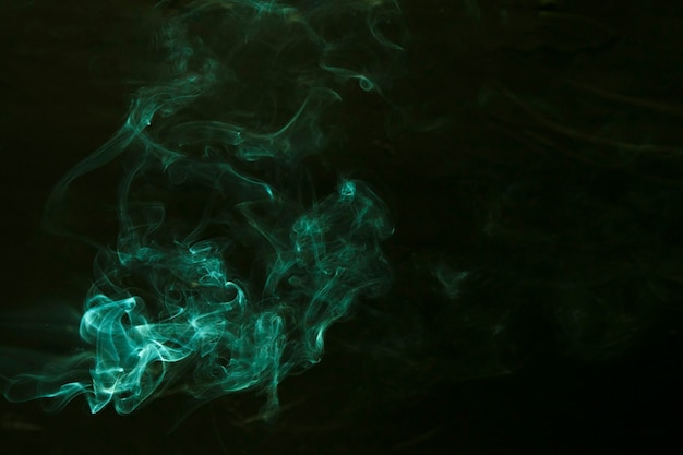 Free photo swirl of green smoke on dark background