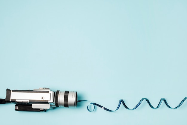 Free photo swirled film stripes from the camcorder on blue background