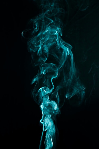 Swirling green smoke on black background