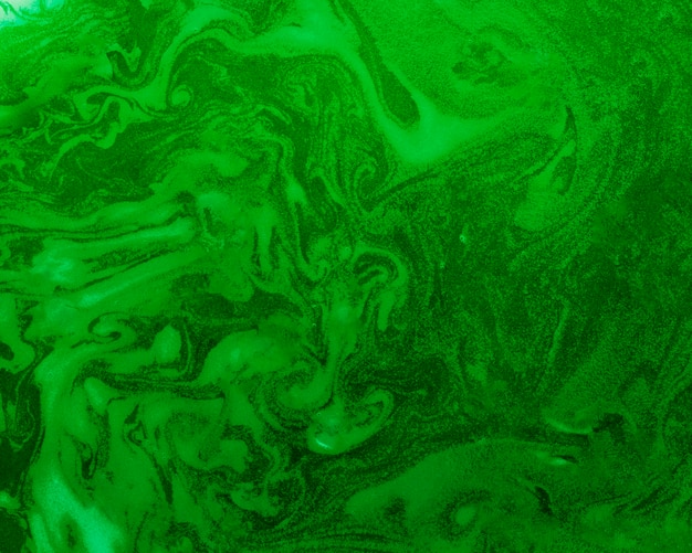 Free photo swirls of foam on green colored liquid