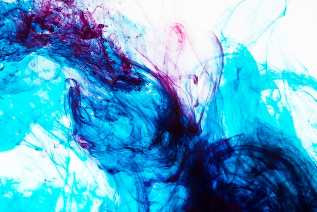 Free photo swirls of inks mixing underwater